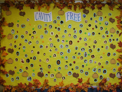 Pictures of children who are cavity-free on a board in the office.