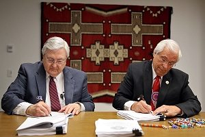 Indian Health Service Principal Deputy Director Robert G. McSwain and Cherokee Nation Principal Chief Bill John Baker sign a Joint Venture Construction Program agreement at the IHS Headquarters in Rockville, Maryland, Feb. 24, 2016.