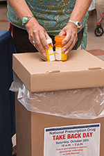A federal employee disposes of unwanted prescription drugs.