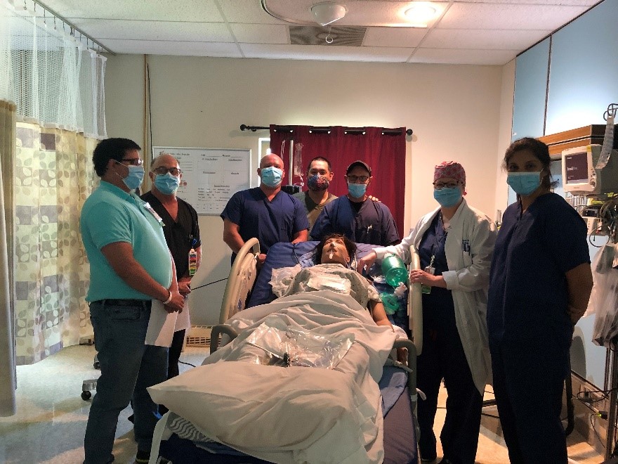 Claremore staff and members of the CCRT conduct training with a patient simulation mannequin at the Claremore Indian Health Hospital.