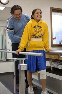 girl doing physical rehabilitation with Physical Therapist