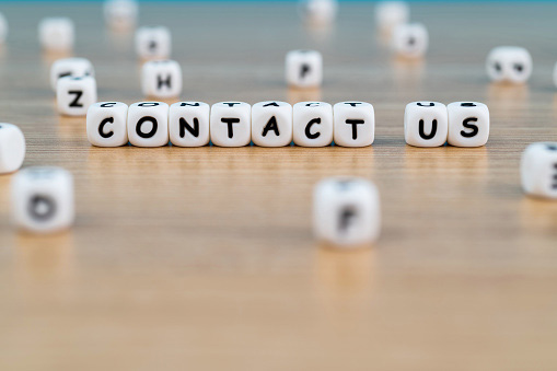 the words contact us spelled out on wooden blocks