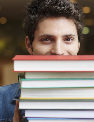 Young man holding textbooks