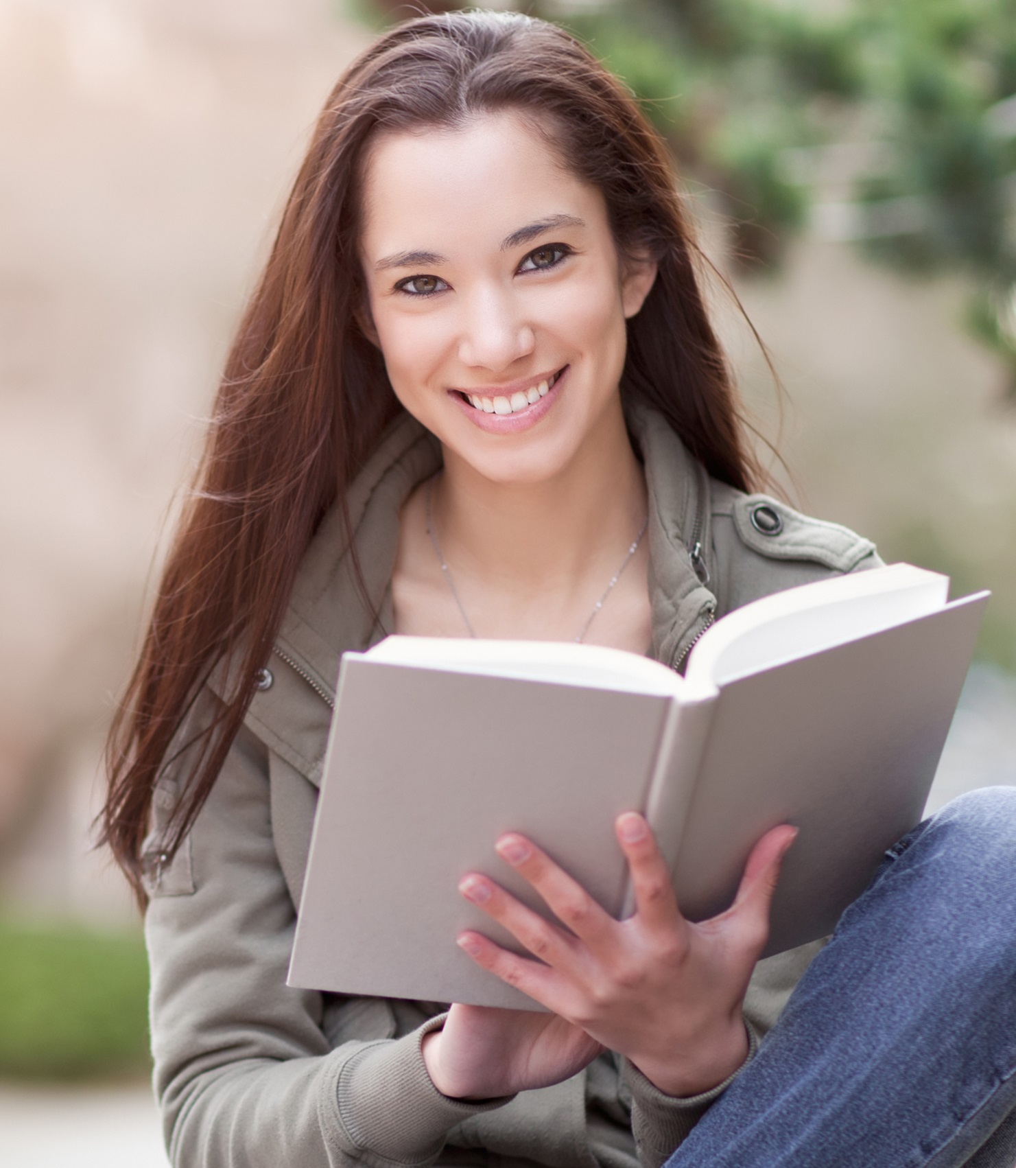 Young woman reading textbook
