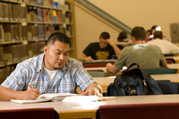Male Student Studies at Library