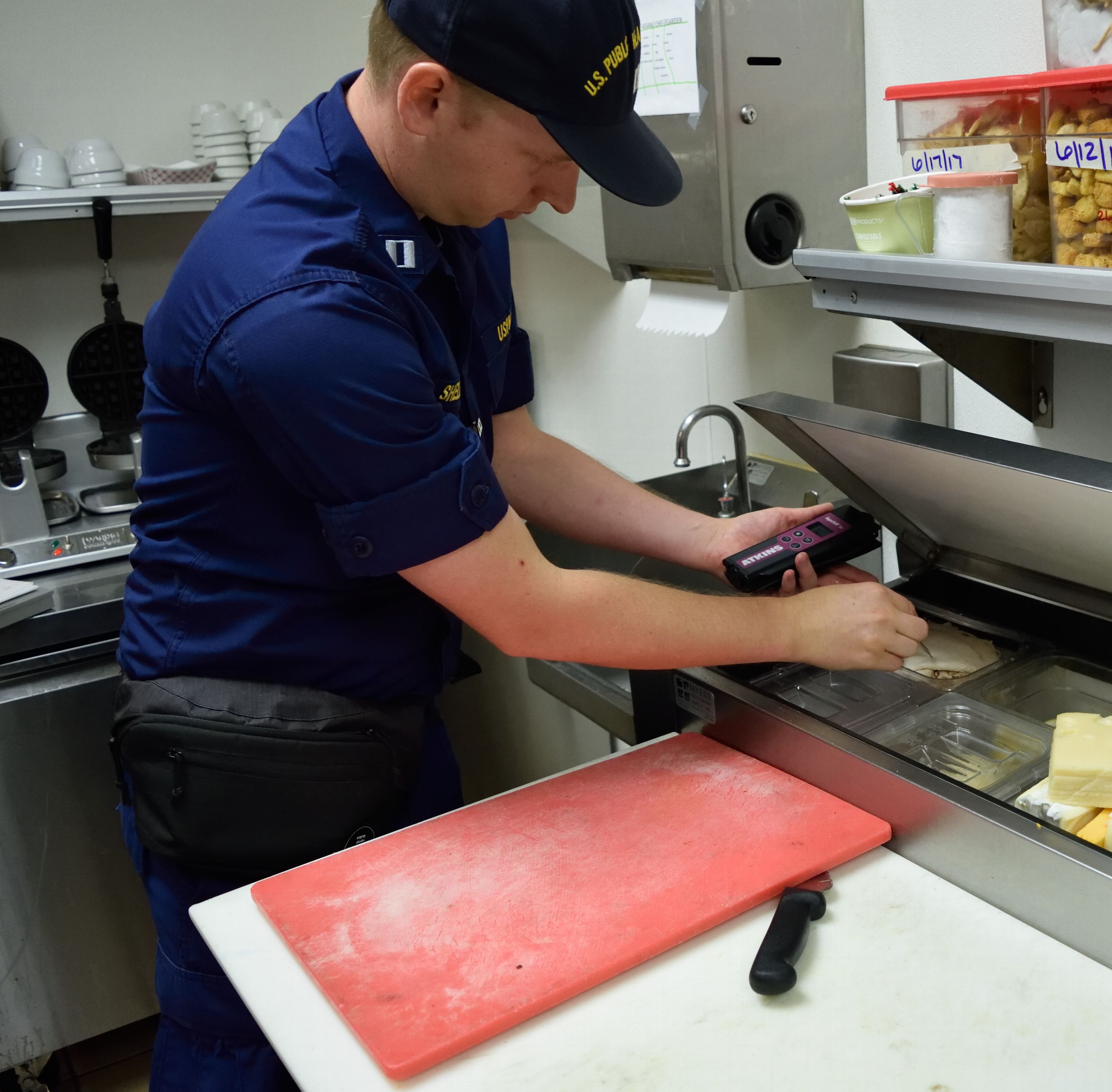 PHS Officer testing food temperatures