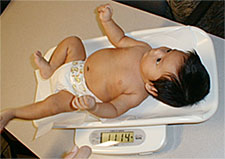 infant being weighed
