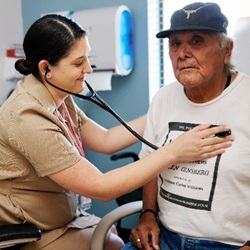 A doctor examining an elder patient