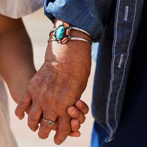 an elder and child holding hands