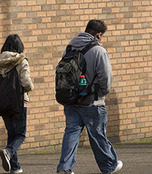 Two teen students walking away