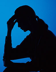 Silhoutte of a woman holding her head