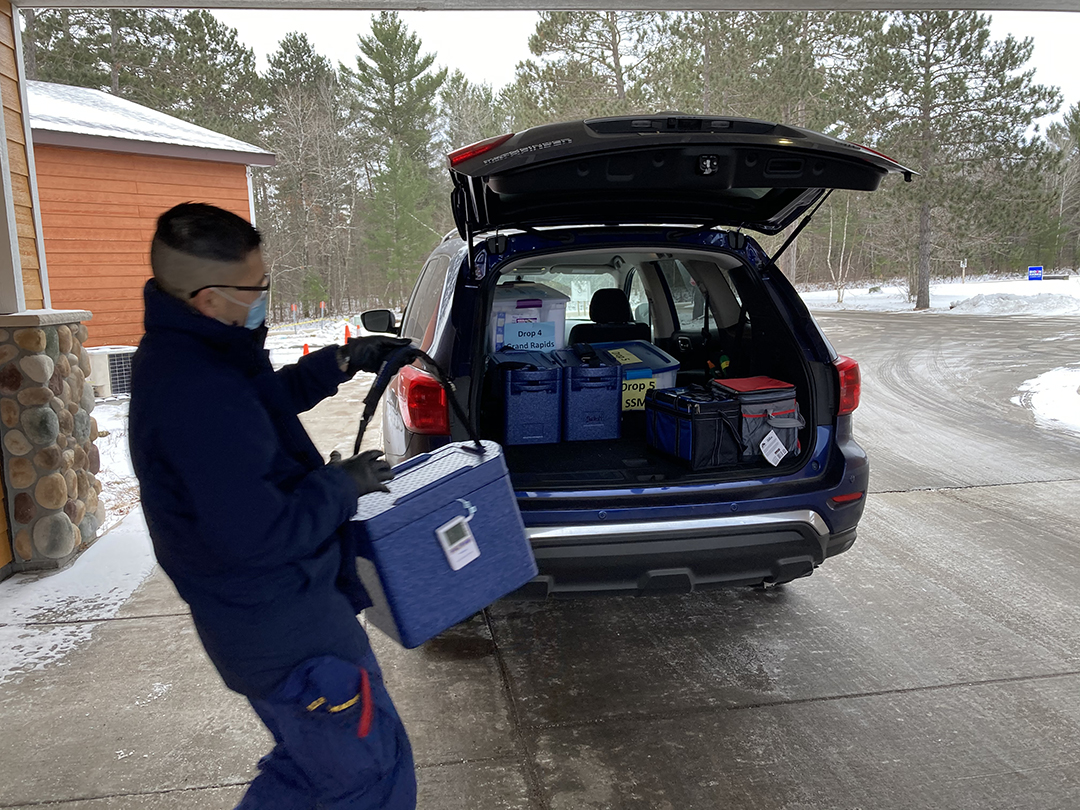 LT Francis Park Loading a Vehicle to Deliver COVID-19 Vaccines and Supplies