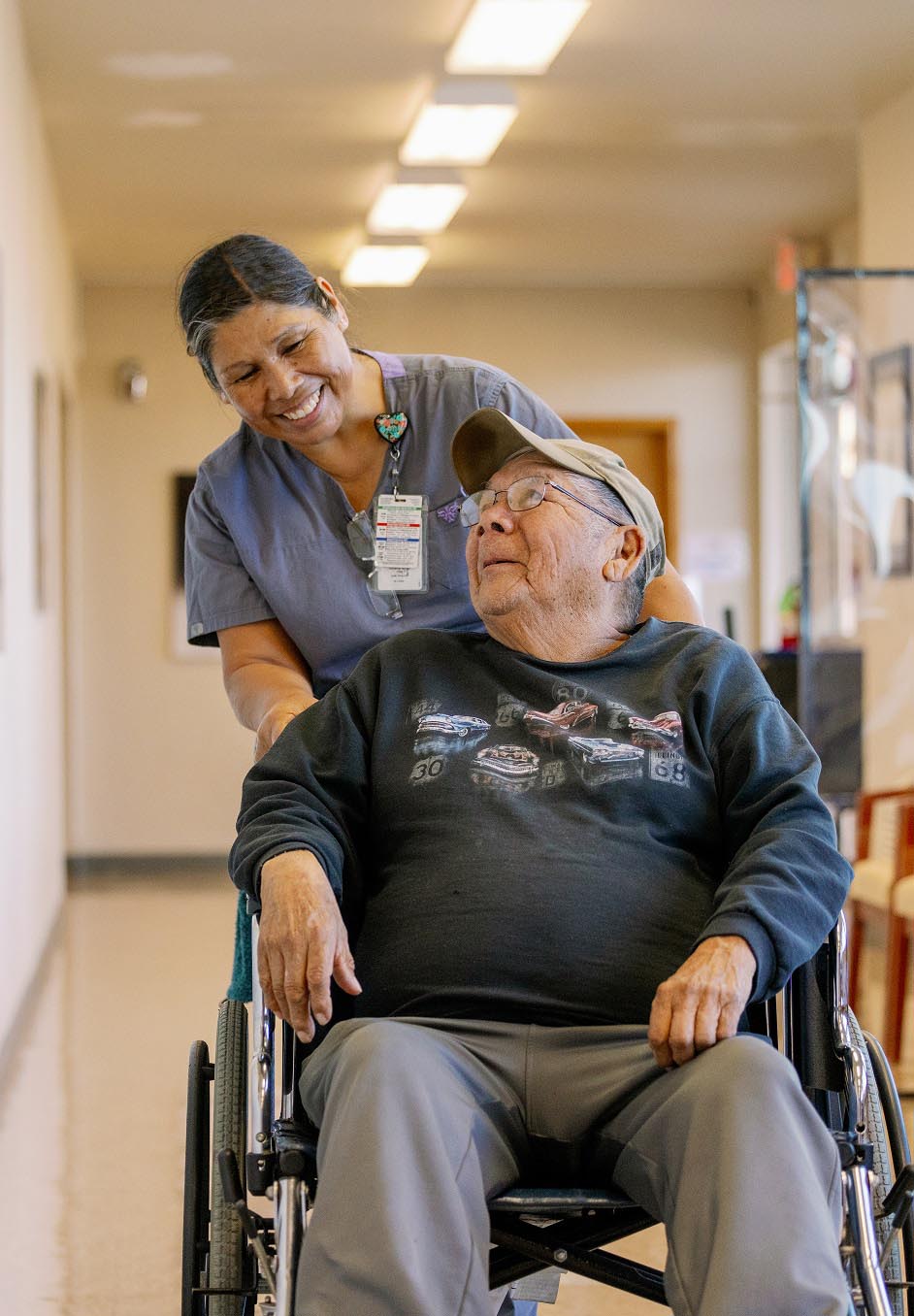 Clinic staff pushing a client in a wheelchair