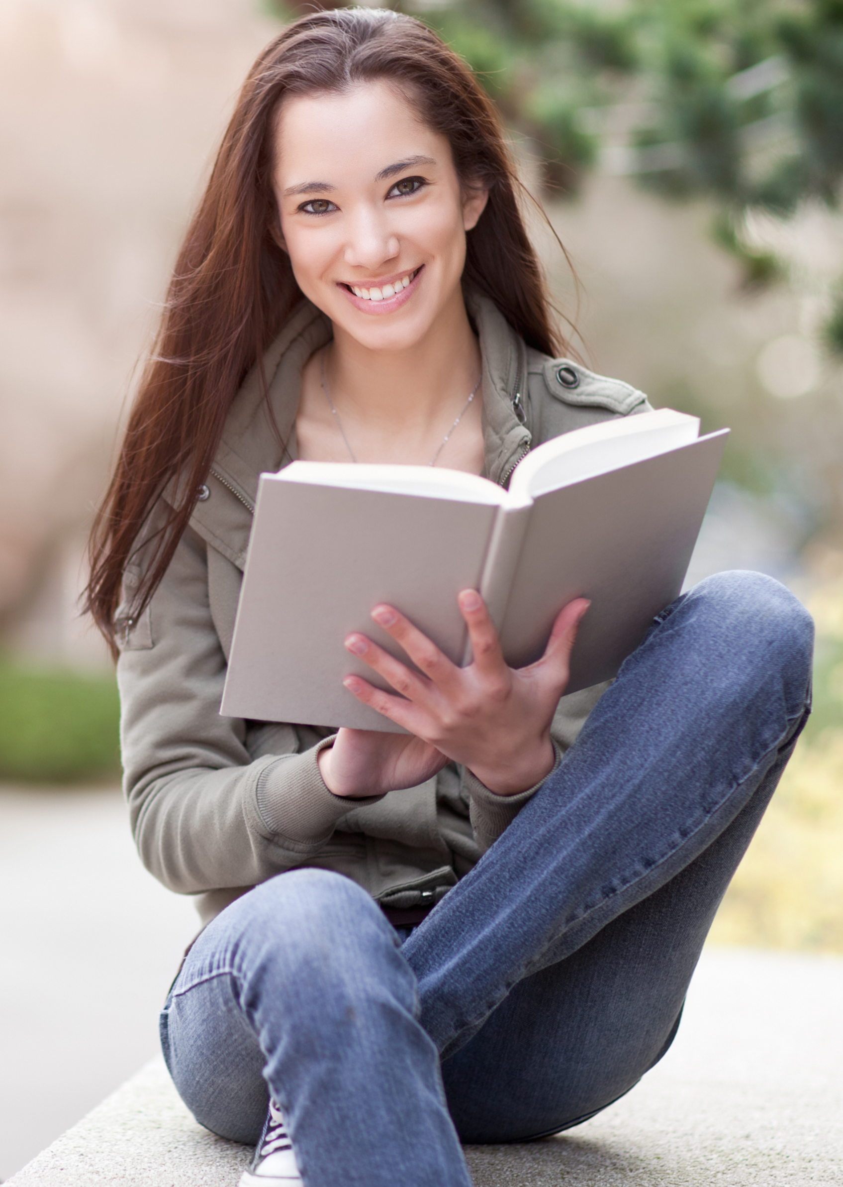 Young woman reading textbook