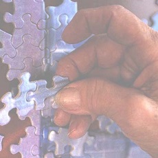 A hand holding puzzle pieces