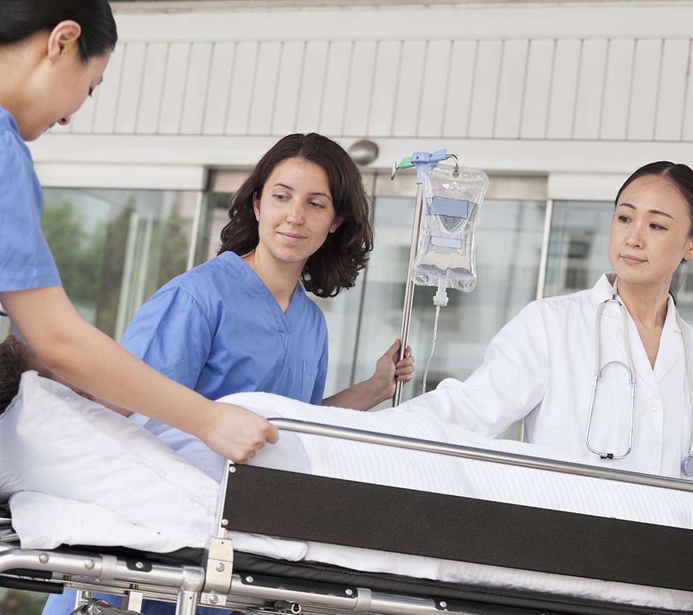 Hospital workers pushing a gurney.