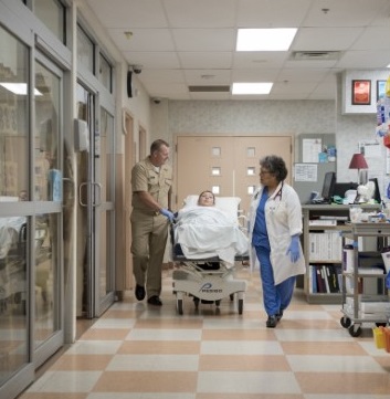 Hospital workers pushing a gurney.