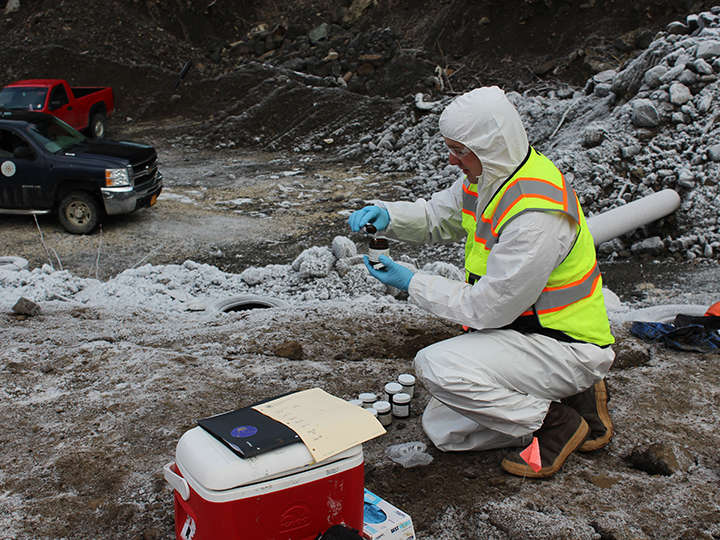 Christopher Fish collects soil samples from a contaminated stockpile in rural Alaska