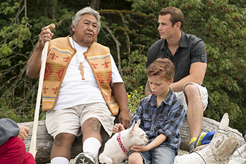 Two men and boy with dog