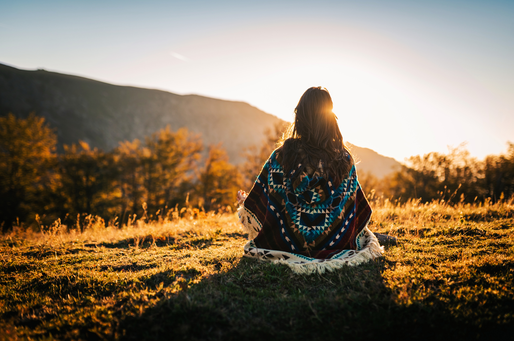 Native American facing sunrise