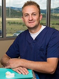 Male medial profession smiling for photo.