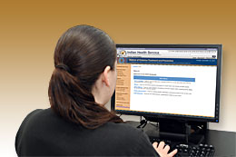 An woman sitting at her workstation