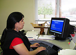 A woman looking at a RPMS screen