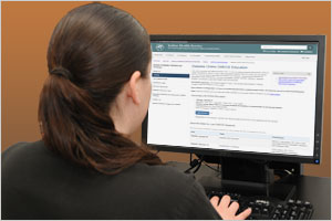 A woman sitting at her workstation looking at the Advancements in Diabetes Seminars landing page.