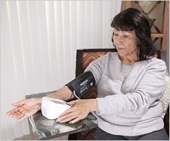 A woman checking her blood pressure