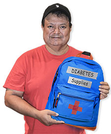 A gentleman holding a diabetes supplies backpack