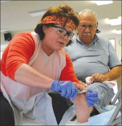 A provider clipping a patients toe nails.