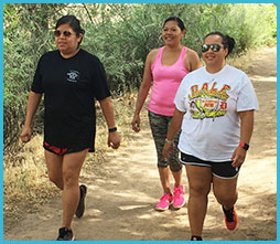 A group of women walking on a trail.