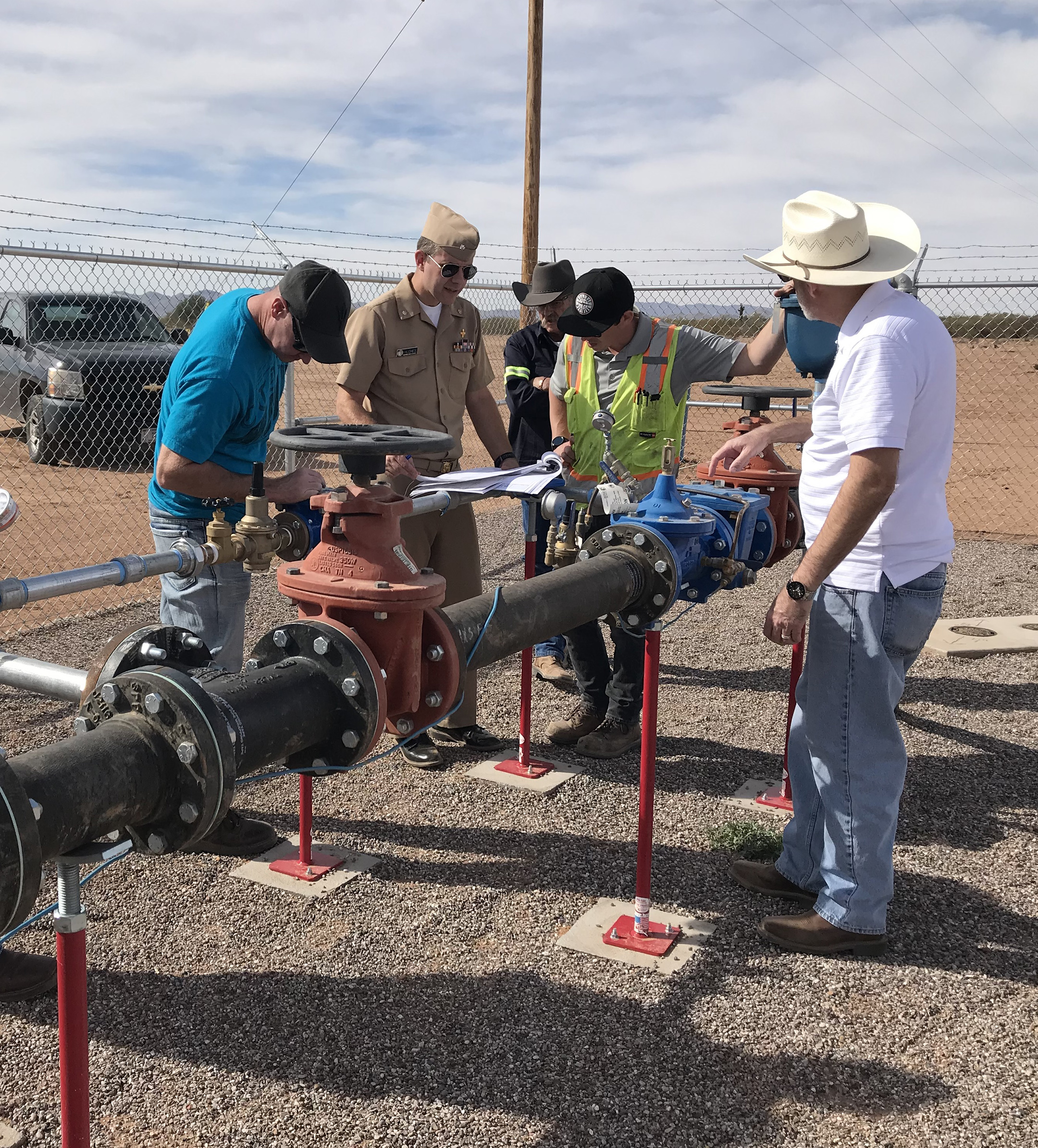 workers fixing pipe