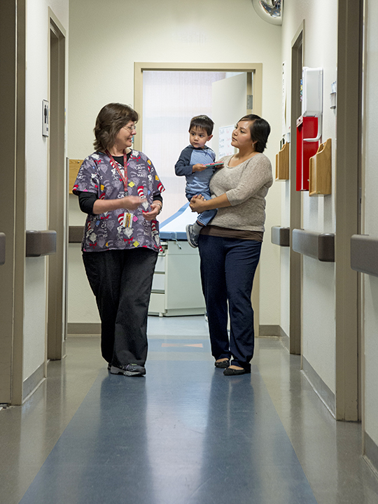 Nurse and mother holding her child.