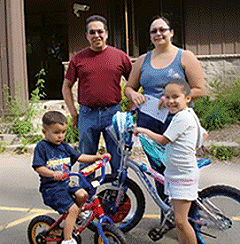 A family poses with bicycles