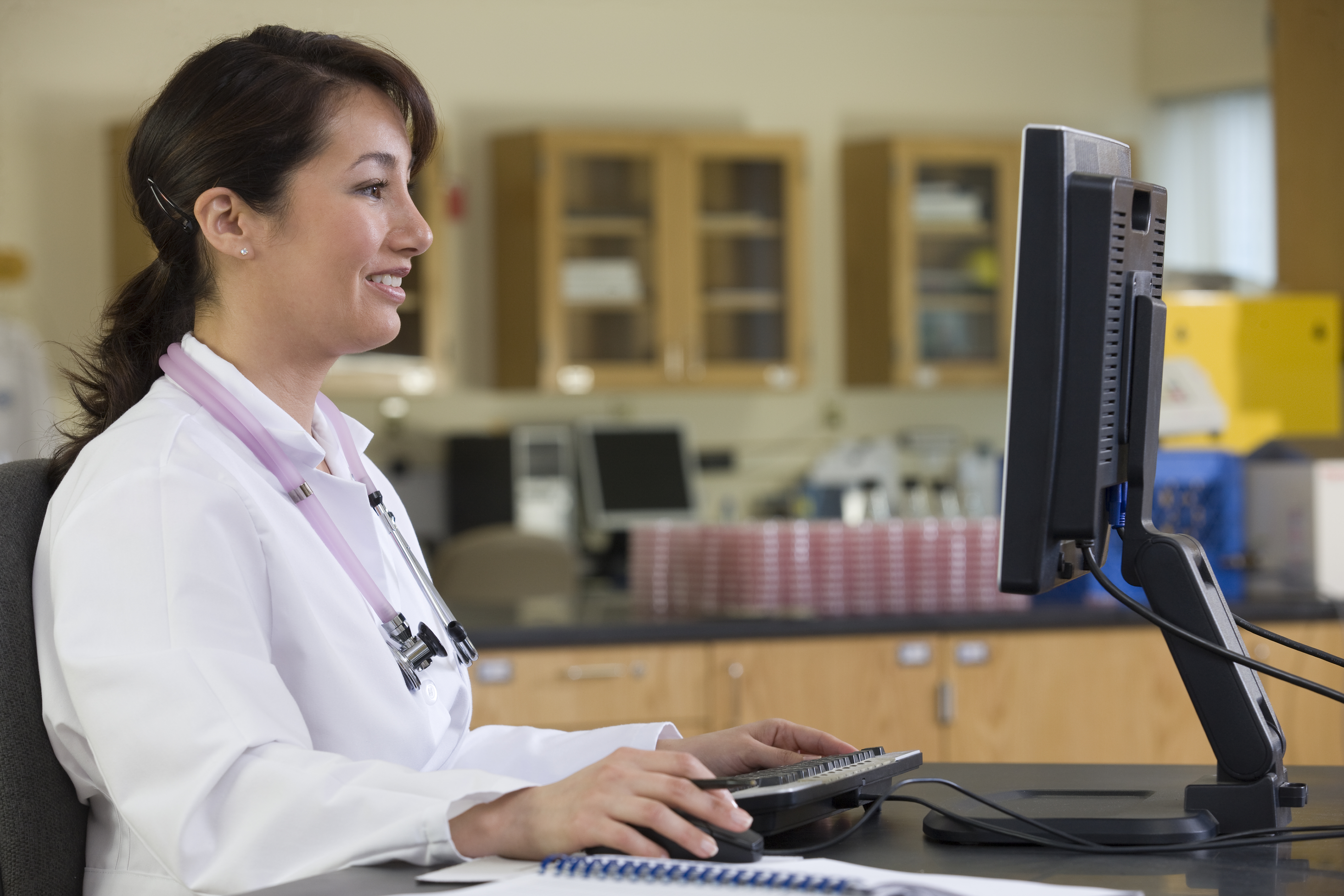 medical staff members sitting at a computer reviewing patient health information to deliver care to American Indian / Alaska Native patients 