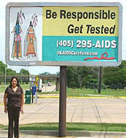 Woman standing under billboard sign - Be responsible Get tested 405-295-AIDS