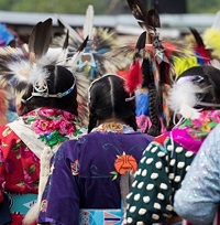 A line of native women at a ceremony