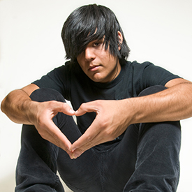 Teen boy making heart shape with hands