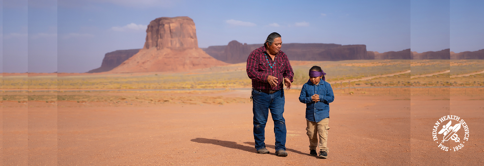 father and son walking around Navajo Nation's Monument Valley