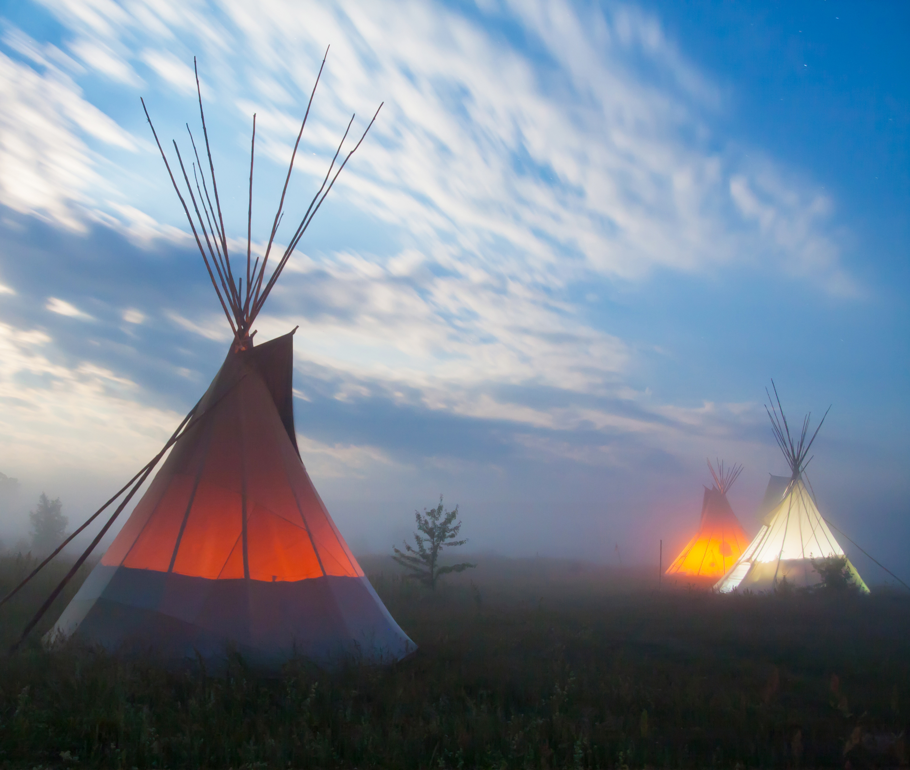 Illumitated tipis at sunset