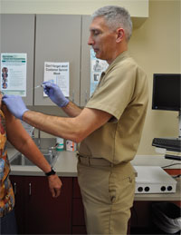 A physician administers a vaccination. A physician administers a vaccination.