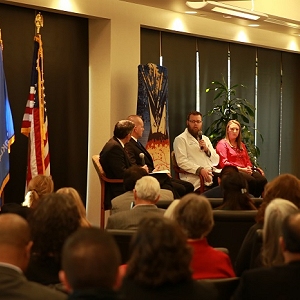 Dr. Micah Nix speaks at a Town Hall Forum at the IHS-funded Indian Health Care Resource Center of Tulsa to discuss the Nation's ongoing prescription drug abuse and heroin epidemic. On stage (from left) are Michael Botticelli, Director of National Drug Control Policy at the White House; John Hobbs, Public Safety Director, Choctaw Tribal Police Department; Dr. Micah Nix, Emergency Department Director at Claremore Indian Hospital and Kelly R. Mounce, Project Director of Systems of Care for the IHCRC.