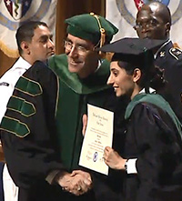 USPHS Lt. Vinita Puri receives her Doctor of Medicine diploma during the Uniformed Services University School of Medicine commencement ceremony in Washington, D.C., May 21, 2016.