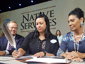 Boys & Girls Clubs of America President and CEO Jim Clark; IHS Division of Behavioral Health Director Beverly Cotton, DNP, a member of the Mississippi Band of Choctaw Indians; and Boys & Girls Clubs of America National Director of Native Services Carla Knapp, a member of the Penobscot Indian Nation, during a signing ceremony for an agreement between their organizations in Dallas, Texas, May 12, 2017.