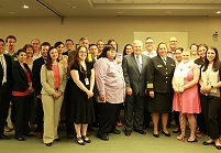 Thumbnail - clicking will open full size image - A group of about 30 meeting attendees and IHS staff gathered for a group photo in the conference room during the IHS Meeting on American Indian and Alaska Native Lesbian, Gay, Bisexual, and Transgender Health Issues.