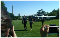 Thumbnail - clicking will open full size image - President Barack Obama and First Lady Michelle Obama walking from the Marine One helicopter