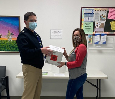 Lt. Cmdr. McElwee, a pharmacist at the Pawnee Indian Health Center, providing a sharps container for patients to mail back for the destruction of used sharps.