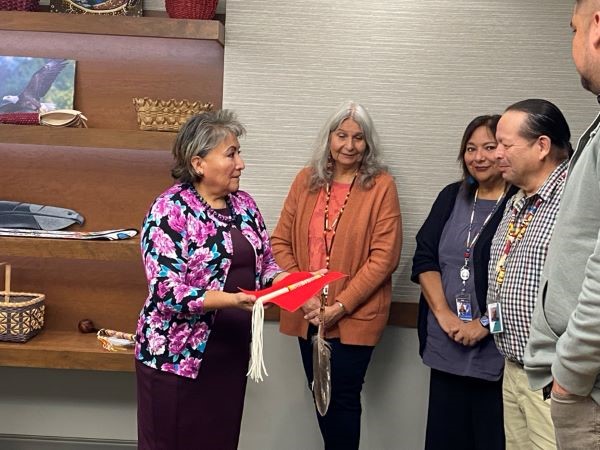 Director Roselyn Tso visit the Gun Lake Tribal Health Center and receiving a talking stick and feather