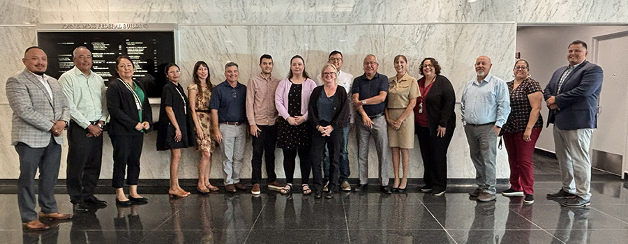 IHS Agency Lead Negotiators together in front of a wall